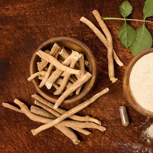 Wooden bowls with dried roots and powder on a wooden surface